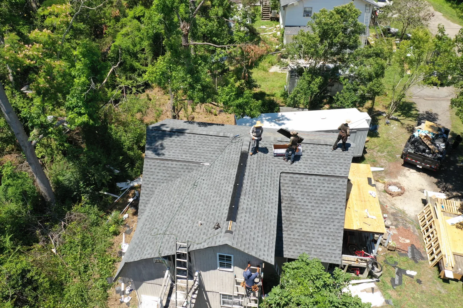 Patriots Roofing emergency crew tarping a storm-damaged roof