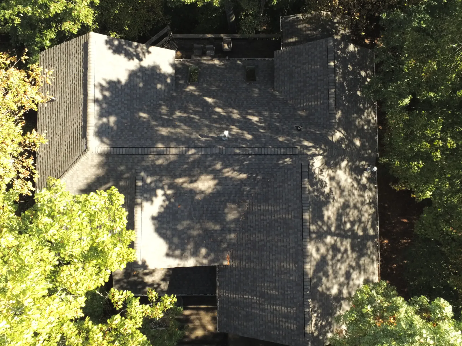 Completed shingle roof replacement, aerial view