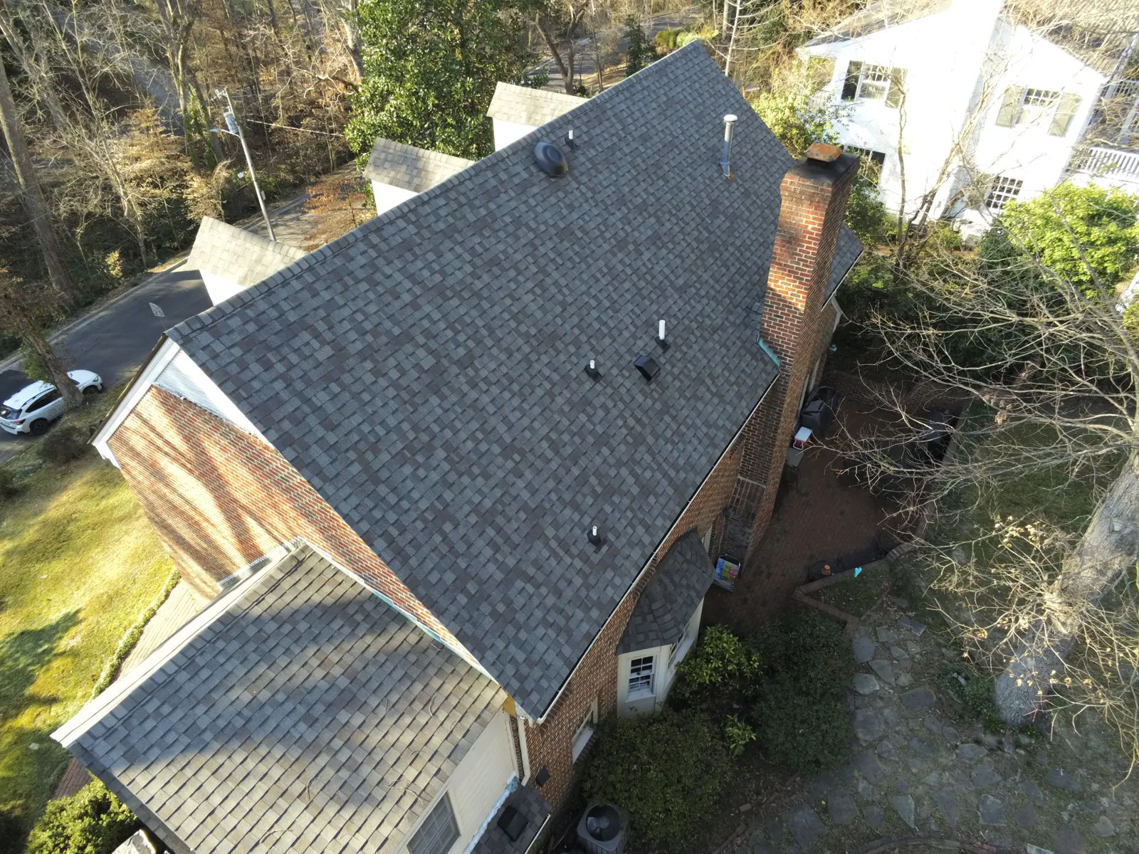 Finished architectural shingle roof on a brick home by Patriots Roofing