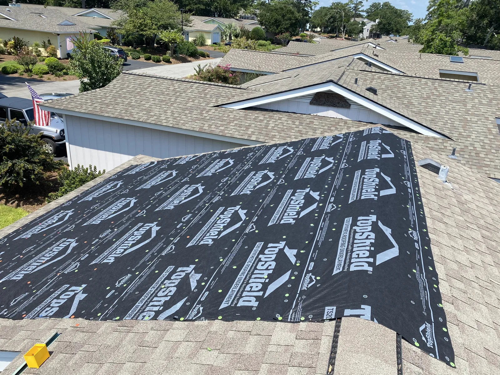 New synthetic underlayment laid over roof decking to dry in the roof during a repair