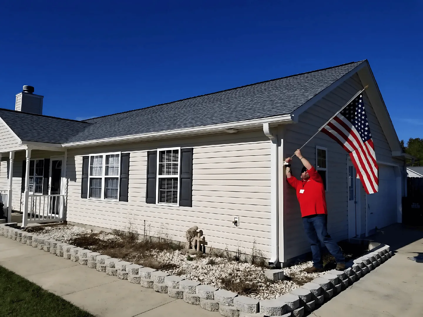 American flag flying on a Patriots Roofing project