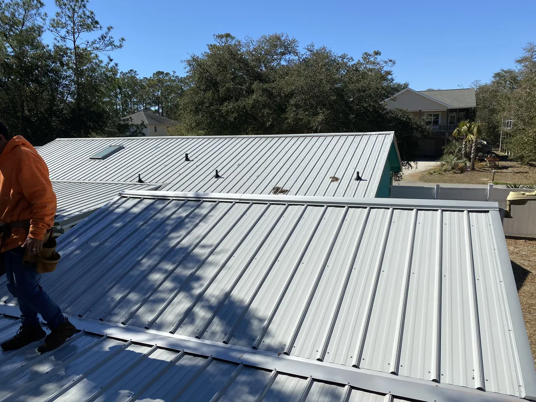 Metal roof panels and ridge detail on a coastal home installed by Patriots' Roofing