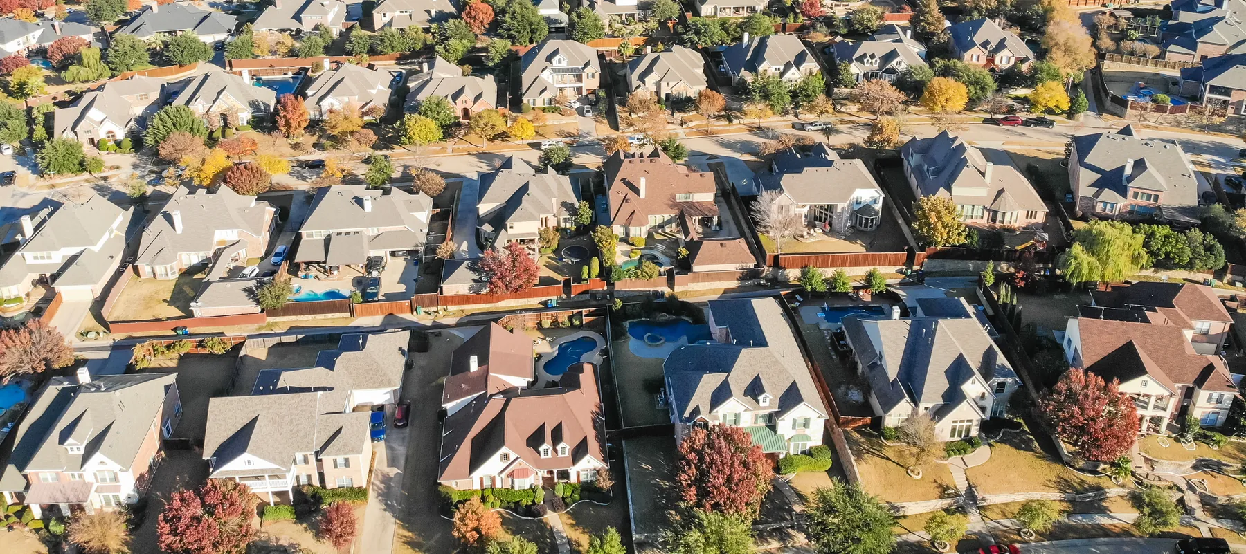 Aerial view of an established residential neighborhood with shingle-roofed homes in Eastern North Carolina