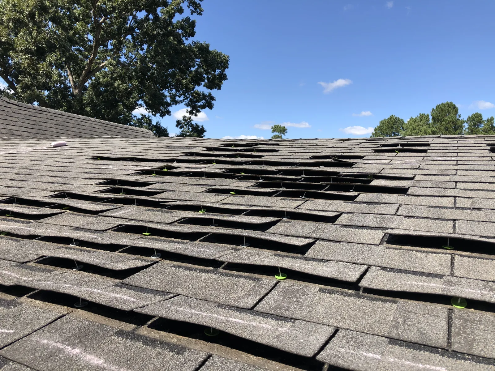 Storm-damaged roof documented for an insurance claim