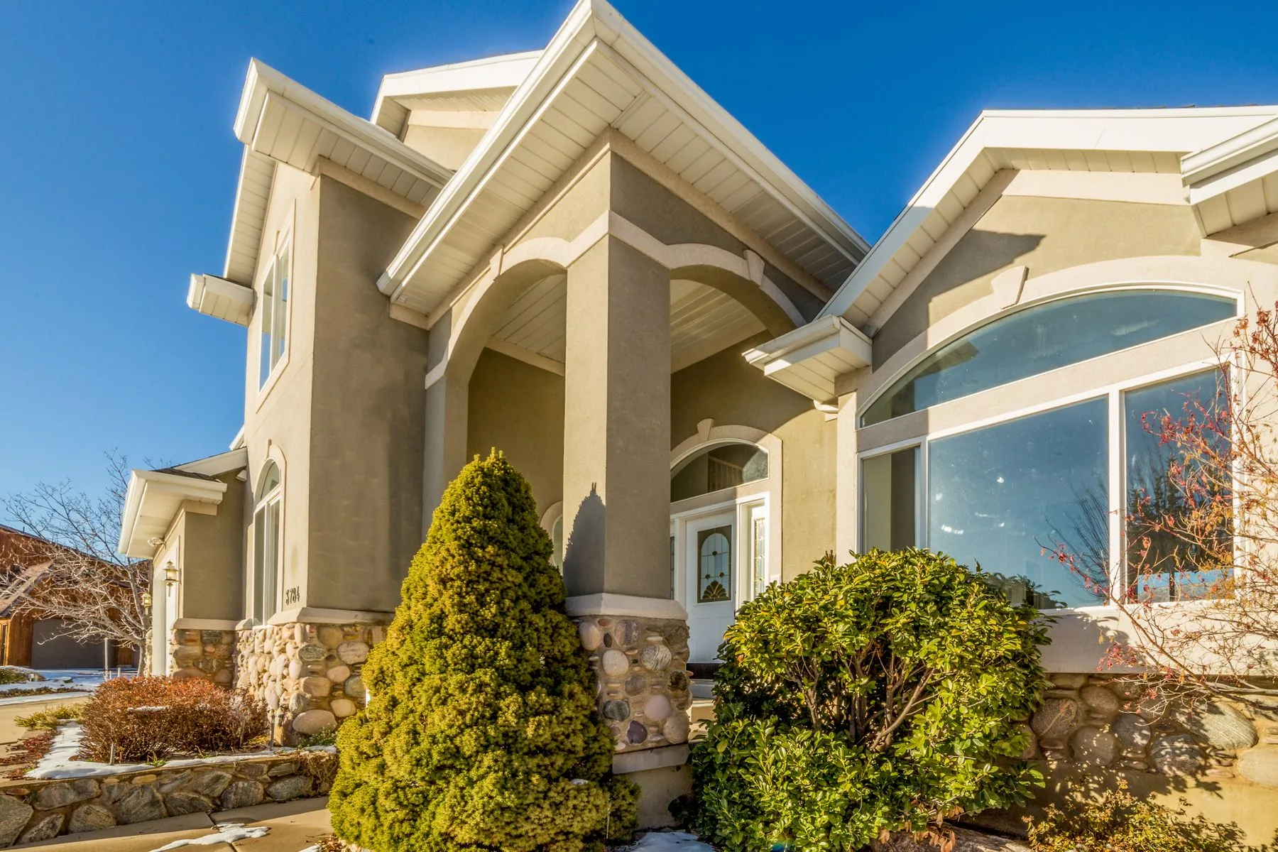 Stucco home with a shingle roof under a clear West Texas sky near Lubbock